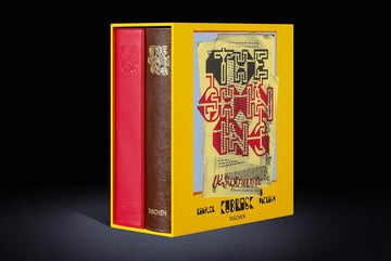 Book with red and brown covers in a yellow box on a black background